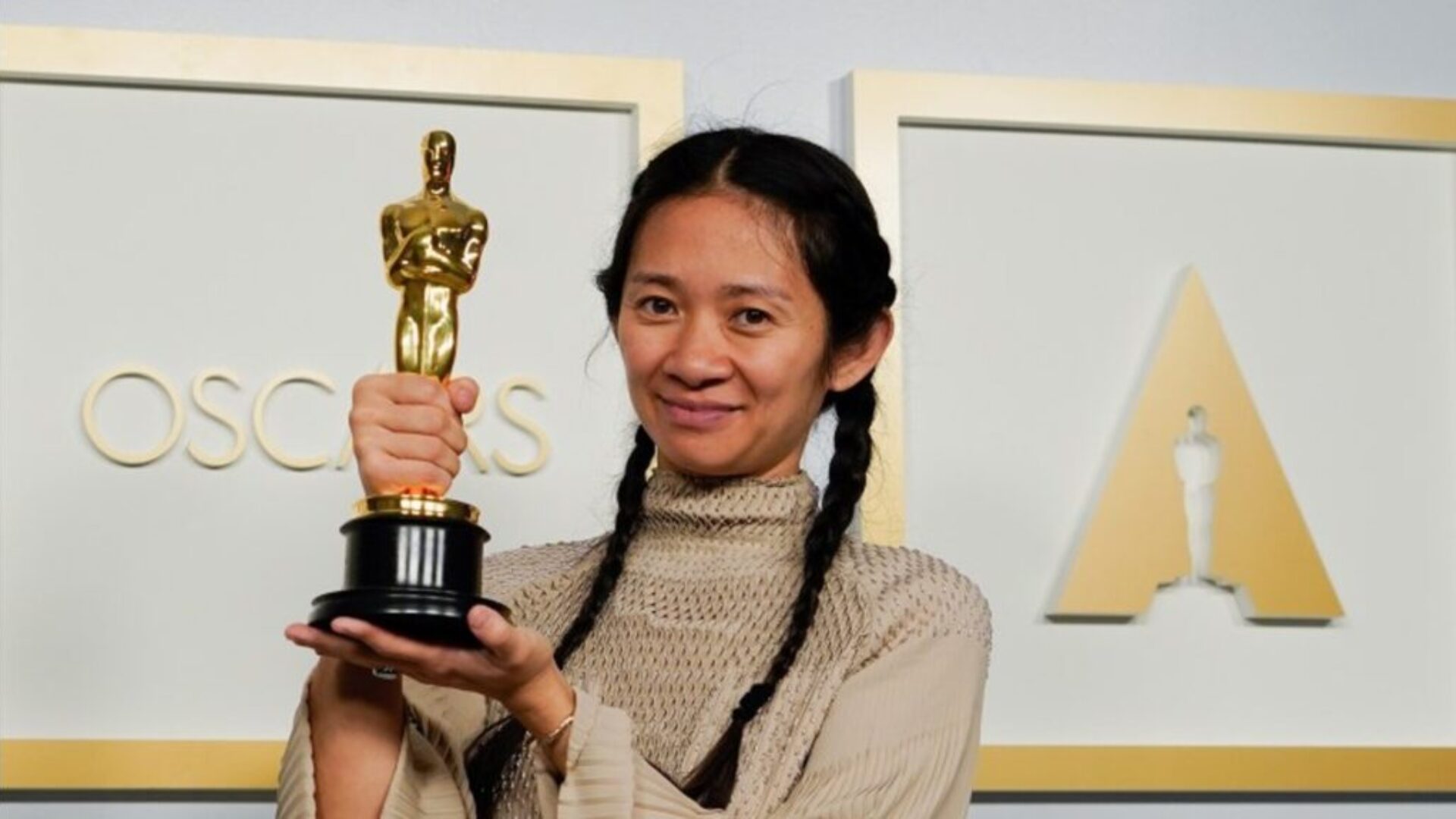 Asian actress holding Oscar